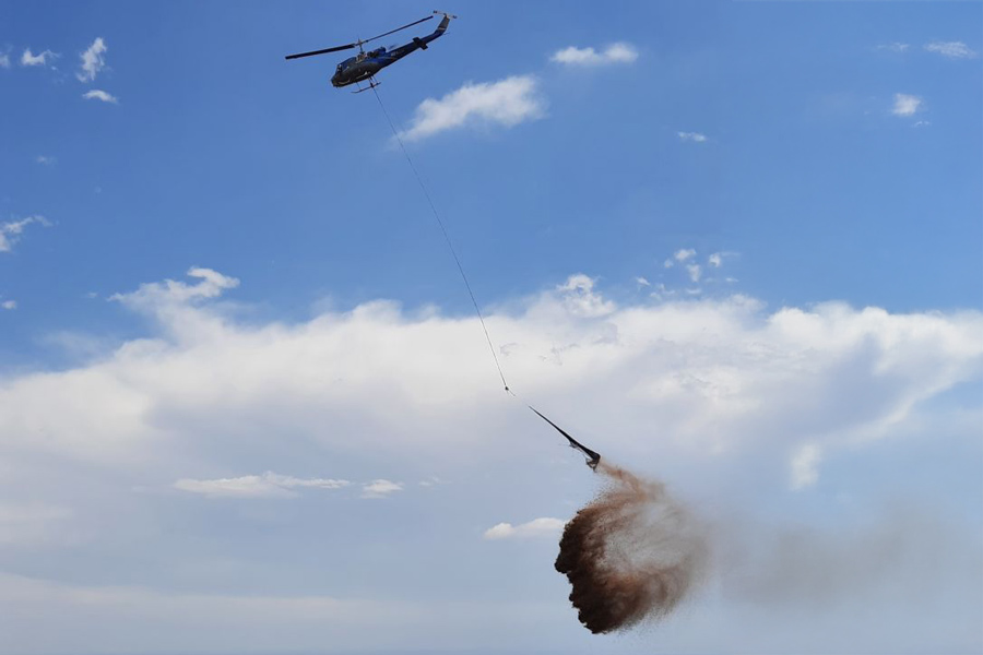 A helicotper drops mulch on a burned area at Heil Valley Ranch to help stabilize the soil